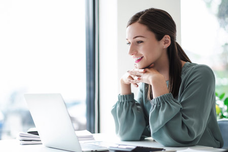 Happy businesswoman working with laptop. business concept.の写真素材