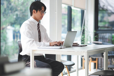 Asian businessman working on laptop.の写真素材