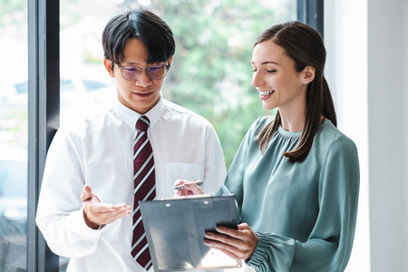 Young confident business people analyze a document with partner, besiness meeting consult. Business conceptの写真素材