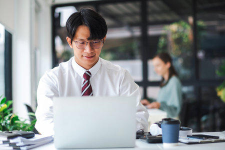 Asian businessman working on laptop.の写真素材