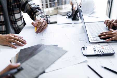 Image of engineer meeting for architectural project. working with laptop and engineering tools on workplace.の写真素材