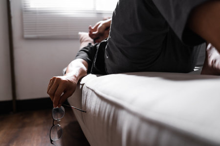 Man hand holding a glasses and lying on sofa for relax.の写真素材