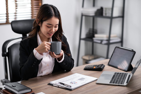 Businesswoman enjoy working with coffee at work place,relax happy. business concept.の写真素材