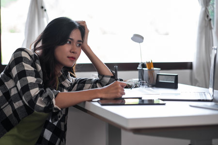 Graphic designer feeling lazy during workの写真素材