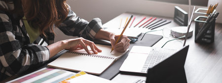 Graphic designer working with sketching logo design at office. Banner design.の写真素材