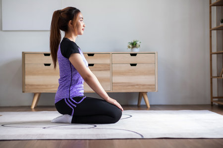 Asian woman in sports wear doing workout at home. home exercise conceptの写真素材