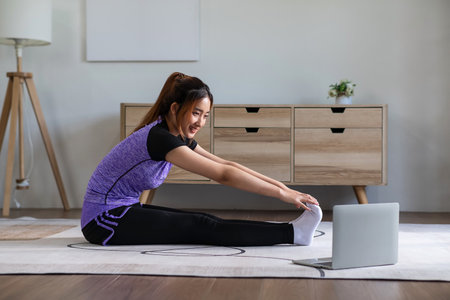 Asian woman in sports wear doing workout at home. home exercise conceptの写真素材