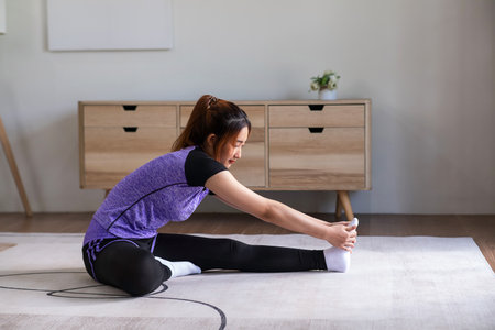 Asian woman in sports wear doing workout at home. home exercise conceptの写真素材