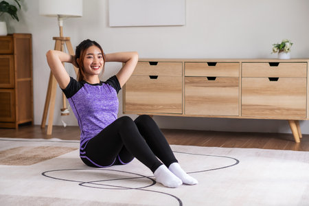 Asian woman in sports wear warm up before workout at home. home exercise conceptの写真素材