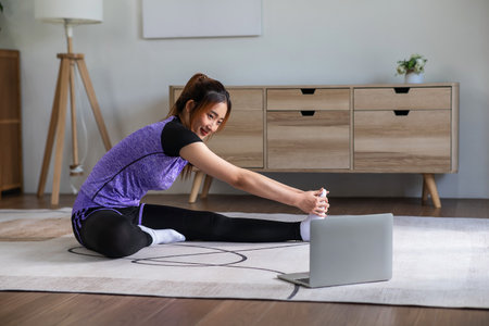 Asian woman in sports wear doing workout at home. home exercise conceptの写真素材
