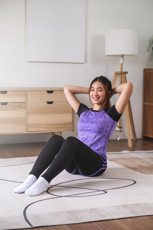 Asian woman in sports wear warm up before workout at home. home exercise conceptの写真素材