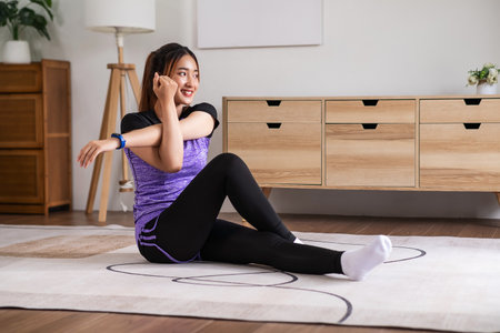 Asian woman in sports wear warm up before workout at home. home exercise conceptの写真素材
