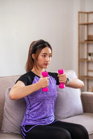 Asian woman exercising at home with swiss ball. home exercise conceptの写真素材