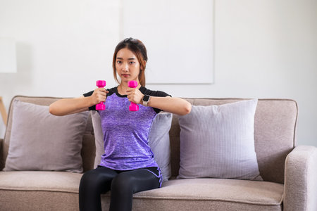 Asian woman exercising at home with swiss ball. home exercise conceptの写真素材