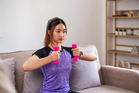 Asian woman exercising at home with swiss ball. home exercise conceptの写真素材