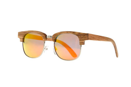 Glasses with wood-metal rim and brown-orange glasses on white backgroundの写真素材