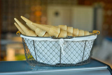 Pile of ice cream cones in the basket background.
