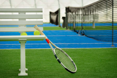 Tennis racket with tennis balls in an indoor tennis centerの写真素材