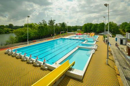 A big blue public swimming pool in nature