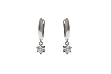 Earrings in the ears jewelry made of silver and gold with crystalsの写真素材