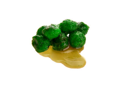 Close up view of green boilies in dip, fishing baits for carp isolated on white backgroundの写真素材