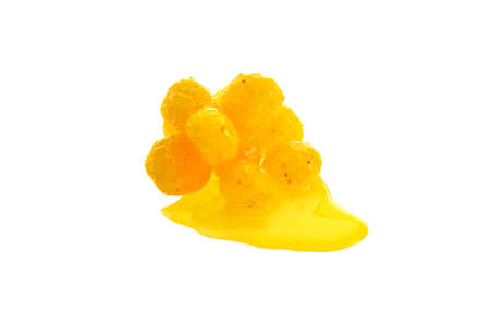 Close up view of yellow boilies in dip, fishing baits for carp isolated on white backgroundの写真素材