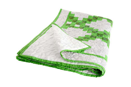 Patchwork green-white quilt on a white background. Patchwork blanket. Handmade. Patchwork quilt on a white background.の写真素材