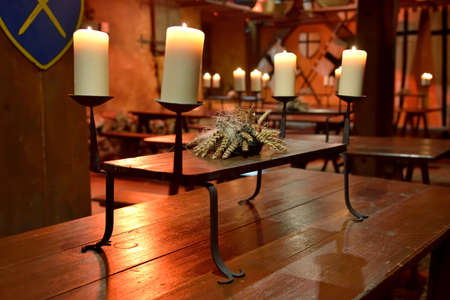 Candles on wooden table with warm yellow fire - the atmosphere of pacificationの写真素材