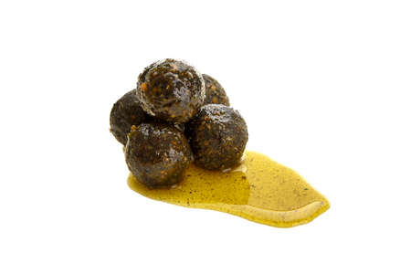 Close up view of green boilies in dip, fishing baits for carp isolated on white backgroundの写真素材
