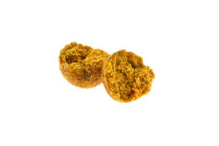 Close up view of broken brown boilies, fishing baits for carp isolated on white background