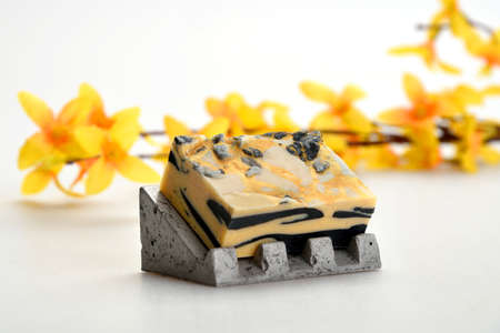 Black-yellow-white soap on a concrete nicheの写真素材