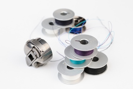 Tailor tools  Metal bobbins of thread and sewing machine shuttle