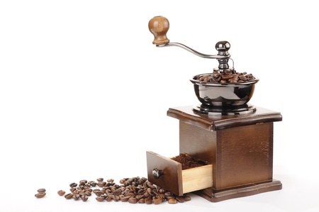 Old coffee grinder and coffee beans on white backgroundの写真素材