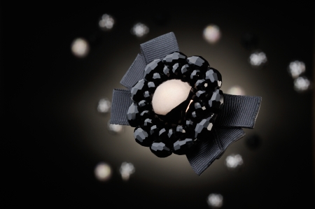 Beads arranged in the shape of a flower on black backgroundの写真素材