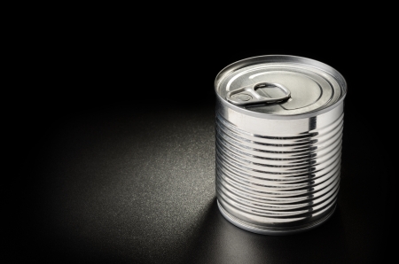 Metallic can on black grained surface