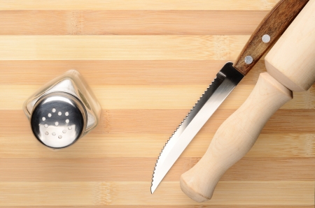 Kitchen accessories  rolling pin, knife, salt on a cutting boardの写真素材