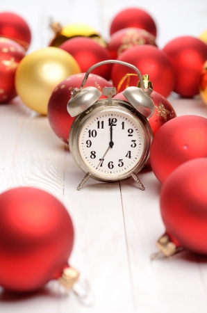 Alarm clock and christmas decorations on wooden plank tableの写真素材
