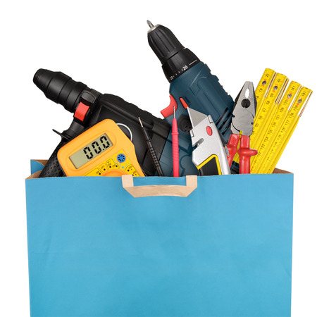 Shopping bag with a different work tools isolated on white backgroundの写真素材