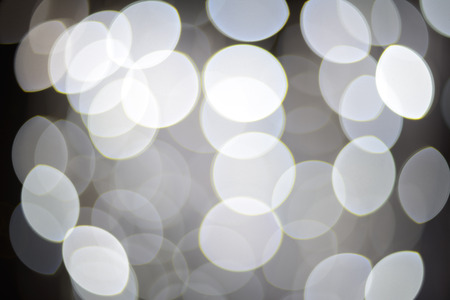 Sparkles and defocused white lights background. Real lens bokeh or blur.の写真素材