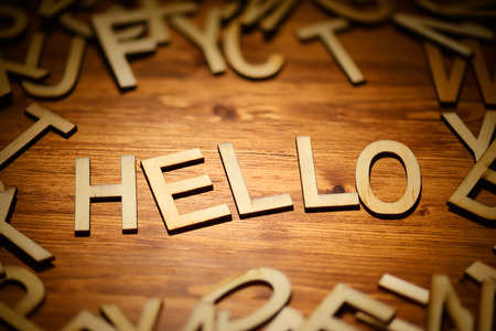 Words Hello written hand made style letters type on a dark wooden backgroundの写真素材