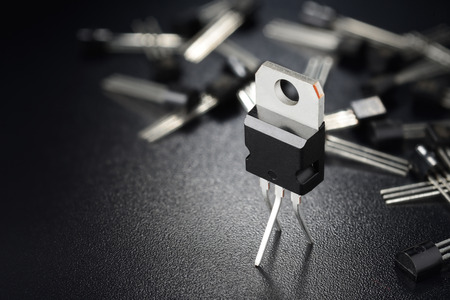 Macro shot of power transistors on the black surface