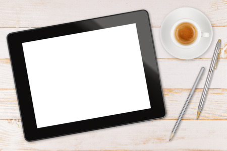 Black touch screen tablet computer with coffee cup, pen and pencil on the plank wooden tableの写真素材