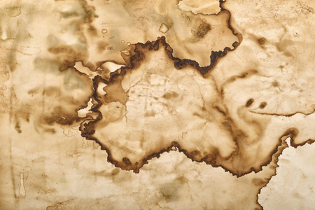 Brown coffee stains and droplets on the paper. Abstract background or textureの写真素材