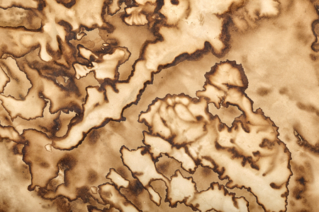 Dirty grunge paper with brown coffee stains and droplets. Abstract background or textureの写真素材