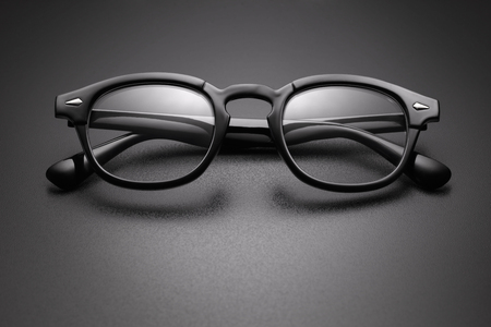 Black plastic eye glasses for vision correction on dark backgroundの写真素材