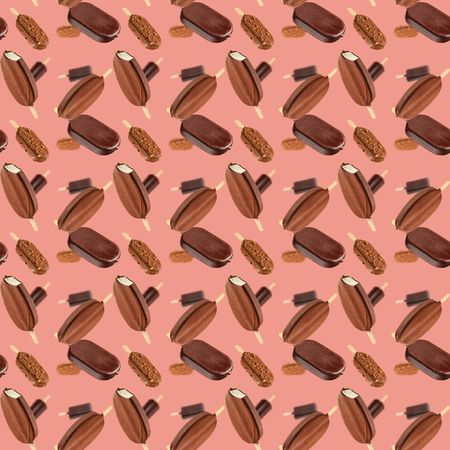 Falling chocolate ice creams on coral color background. Seamless texture or patternの写真素材