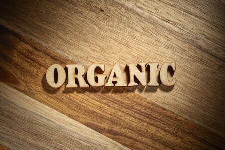 Word organic made with wooden letters on the wood board. Healthy food conceptの写真素材