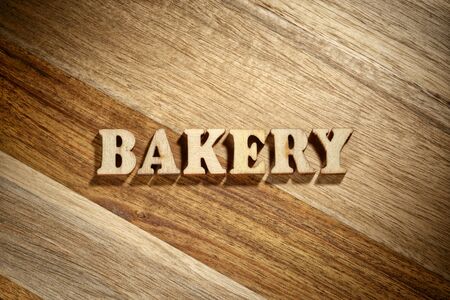 Word bakery made with wooden letters on the wood board. Fresh bread conceptの写真素材