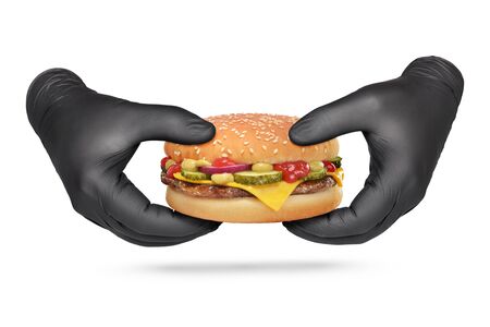 Hand holding or showing cheeseburger in black nitrile protective gloves isolated on white background.の写真素材
