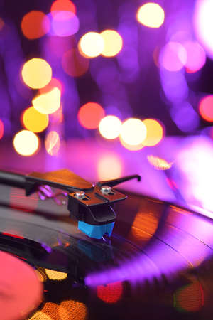 Vinyl player turntable with LP record and blured or defocused lights. Party disco conceptの写真素材